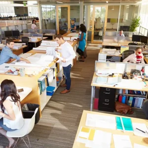 Employees working collaboratively in an open floor plan office 1